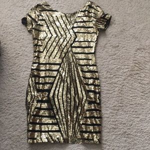 Black/gold sequin dress, above the knee.
